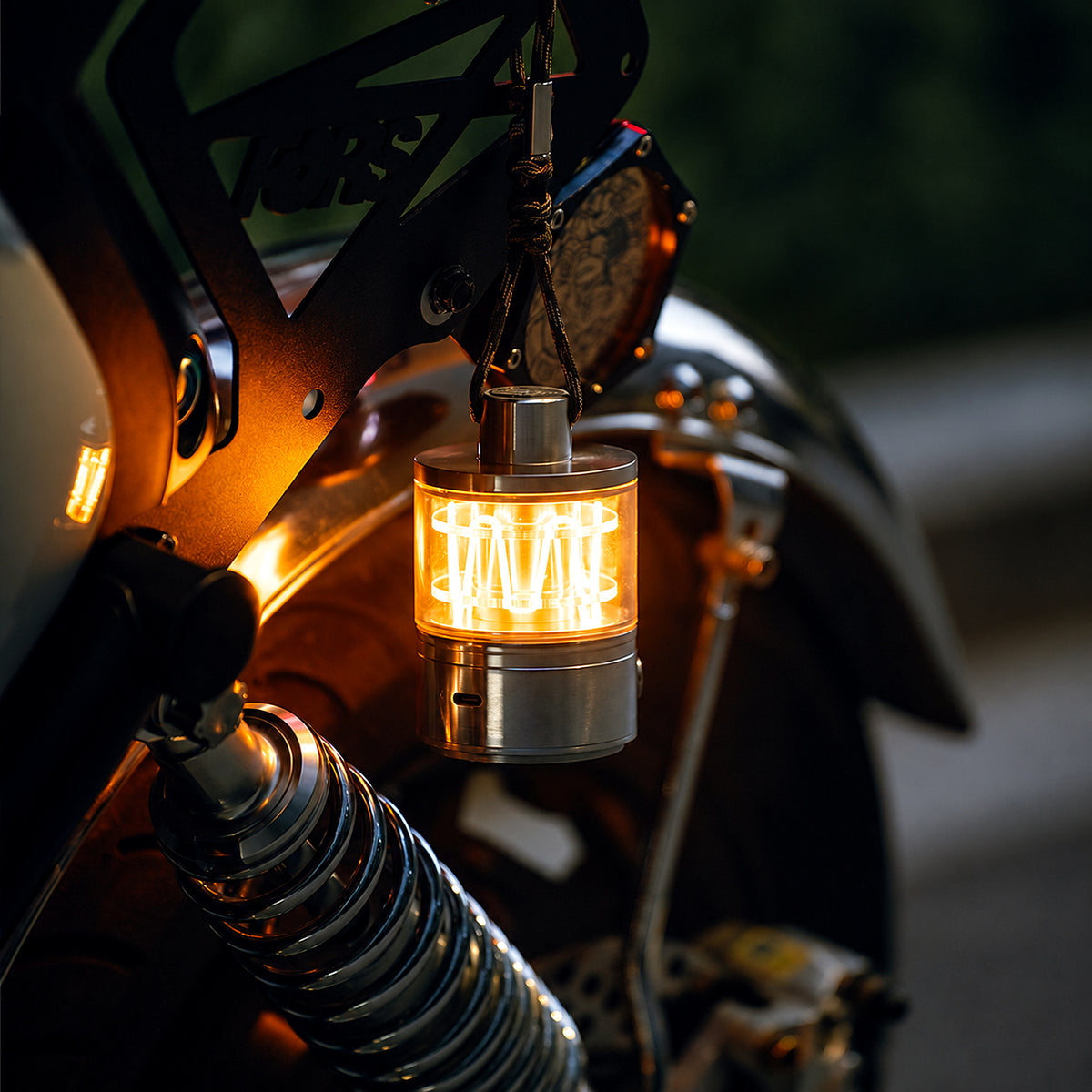 Heartbeat Glow portable lantern casting a warm light beside a motorcycle.