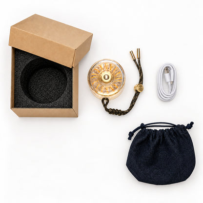 Donut Glow brass lamp package contents with USB-C cable, box, fitted insert and pouch.