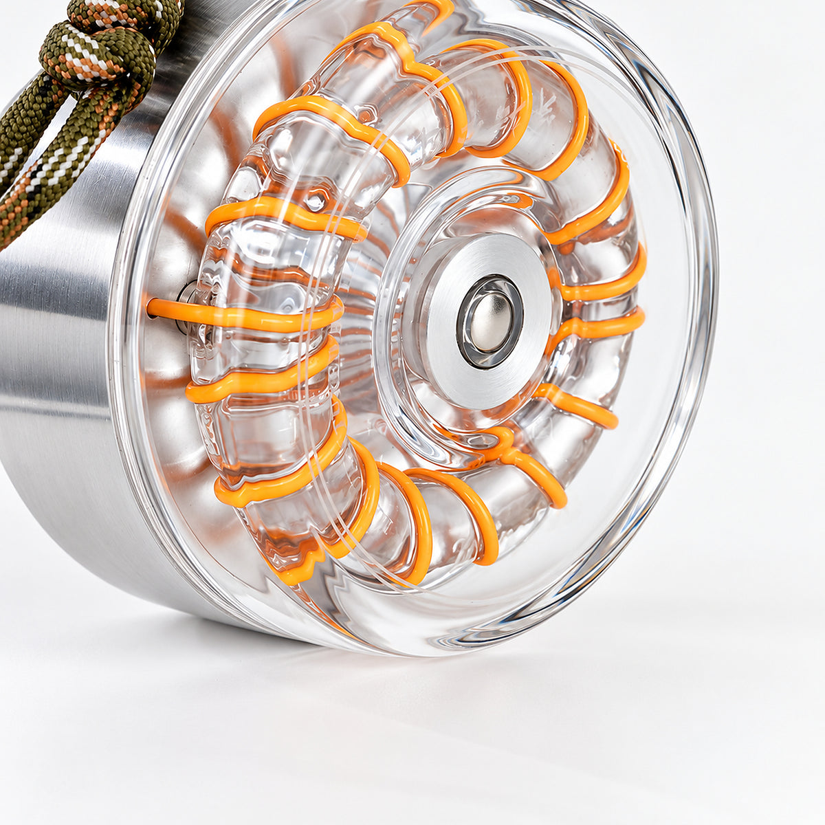 Close-up of the clear glass spiral light path on the Donut Glow aluminum lamp.