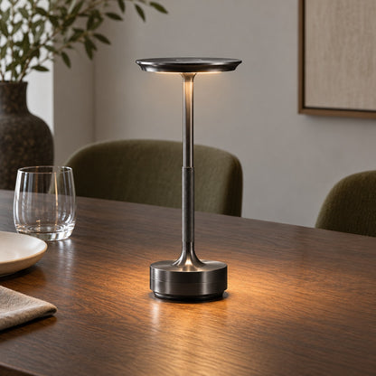 Gunmetal black cordless table lamp illuminating a wooden dining table with warm light - Airayvis
