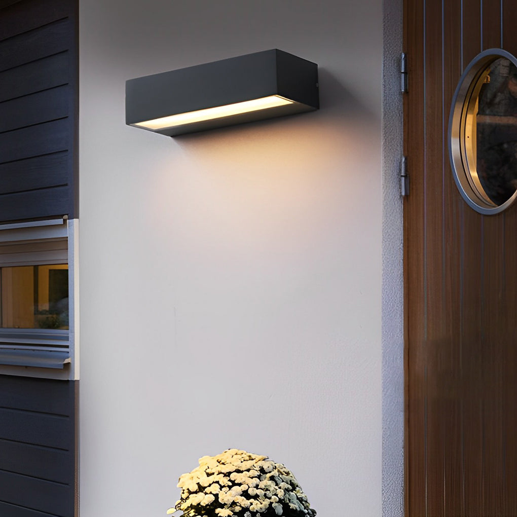 Black exterior porch light fixtures installed above side door providing soft downward illumination.