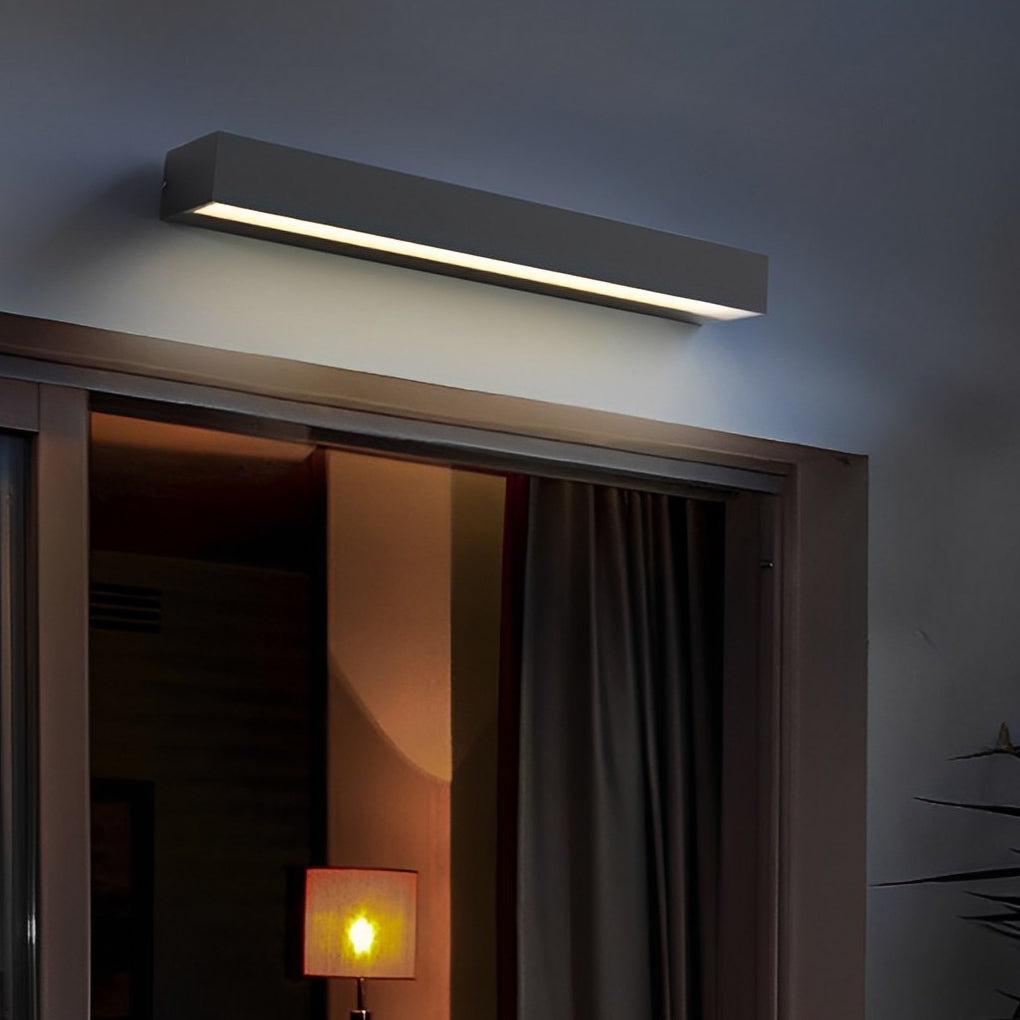 Modern exterior porch light fixtures with slim rectangular design mounted above front door entrance.