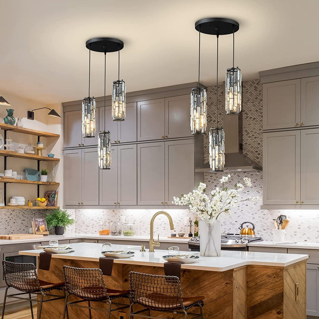 Multiple mini crystal pendant lights installed over a kitchen island with white cabinetry.