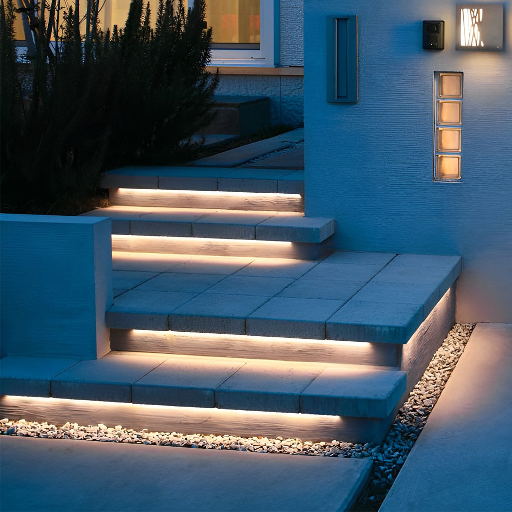 Outdoor embedded LED light strips illuminating a modern patio with subtle, elegant light.
