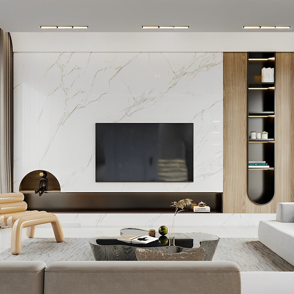 Recessed linear light fixture integrated above a modern TV wall