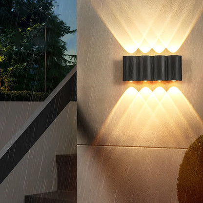 Up and down outdoor wall lights installed on balcony railing with serene evening sky background.